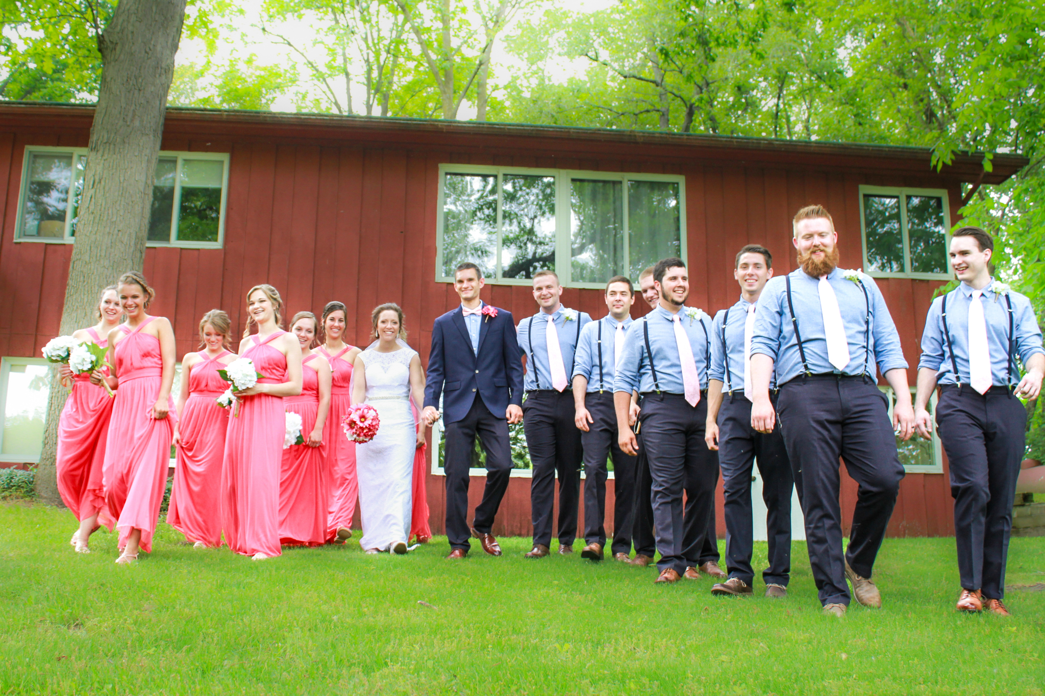 Bridal party all walking together smiling candidly