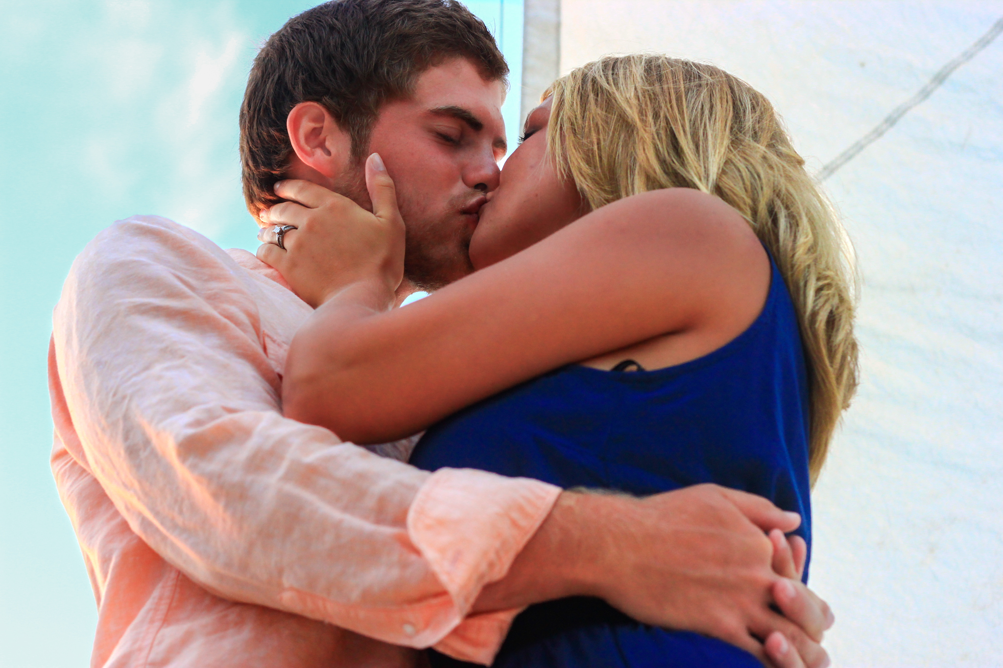 Young couple kiss on sailboat