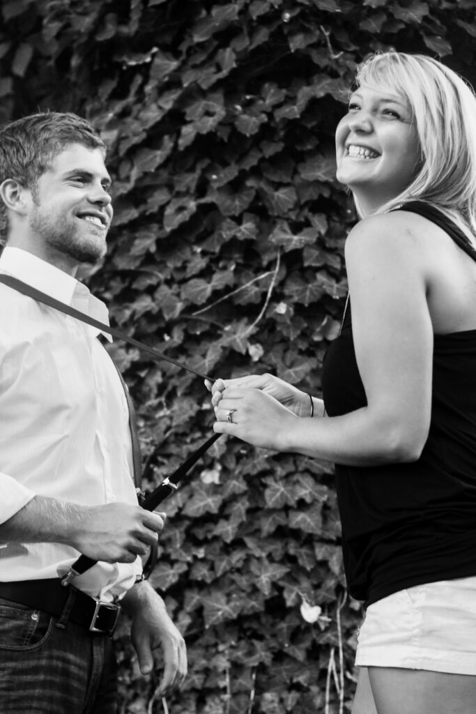 Young couple smiling, woman is pulling on his suspender