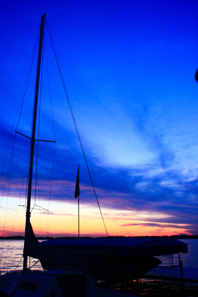 Silhouette of sailboat during sunset on Lake Wawasee in Indiana