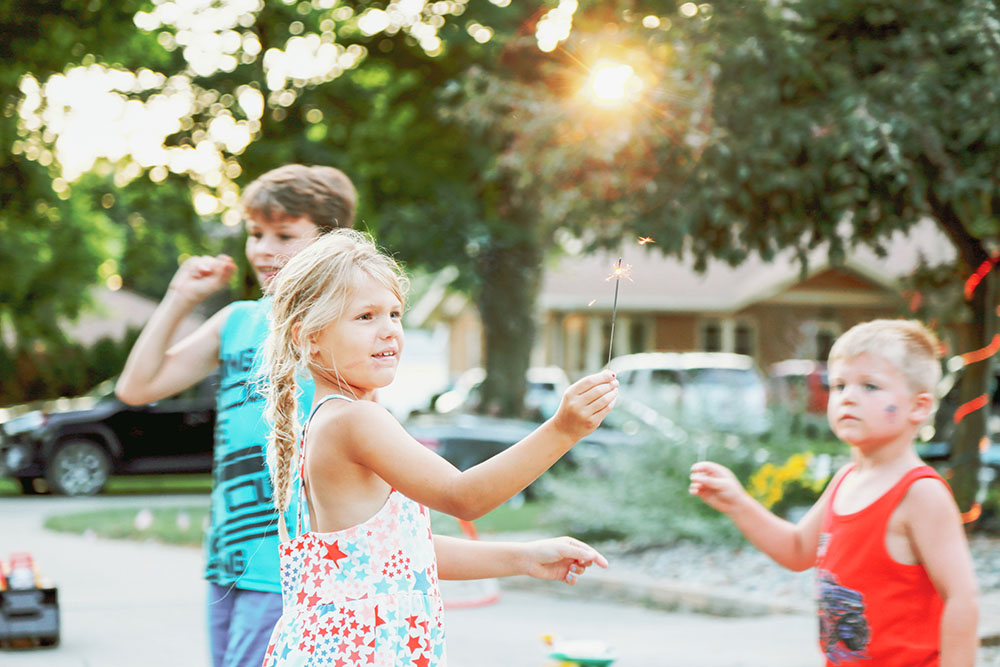 Young girl on 4th of July holding sparkler